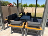 Rear angle of the Lincoln aluminum patio set showing wood-look arm accents